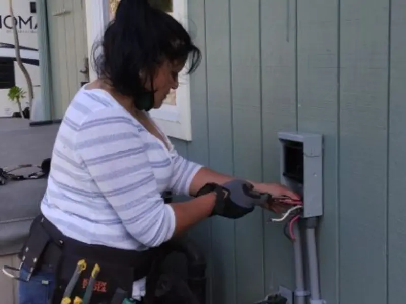 Licensed electrician wiring an exterior subpanel in Marshall